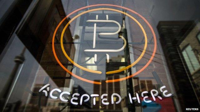 A sign reads "Bitcoin accepted here"