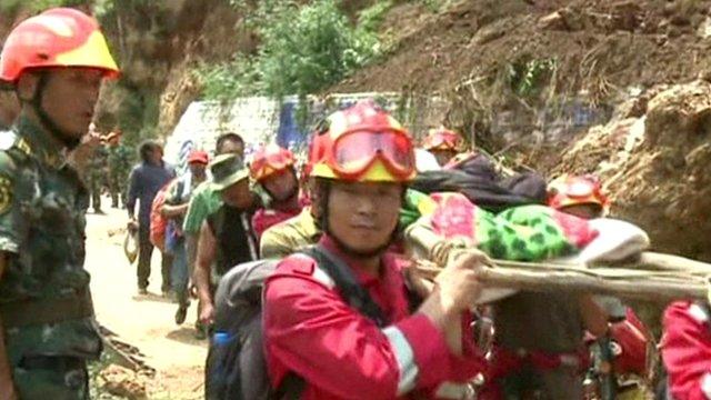 Rescuers carry woman on a stretcher