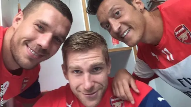 Lukas Podolski (left), Per Mertesacker and Mesut Ozil