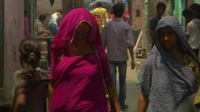 Indian women walking down a street