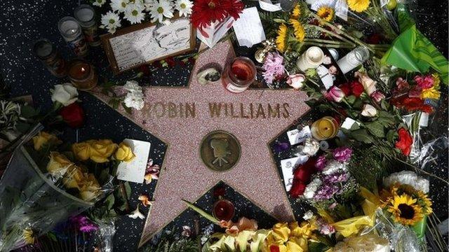 Flowers surround Robin Williams' star on the Hollywood Walk of Fame