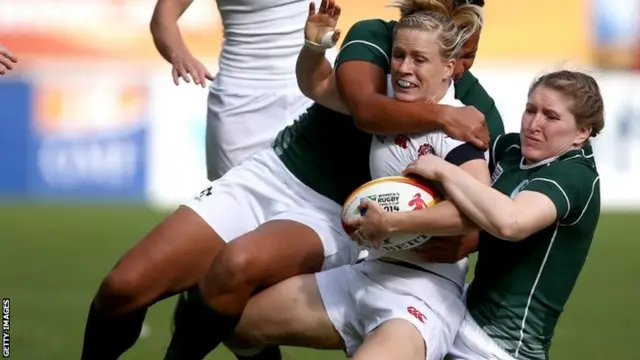 Danielle Waterman of England is tackled by Sophie Spence and Heather O"Brien of Ireland