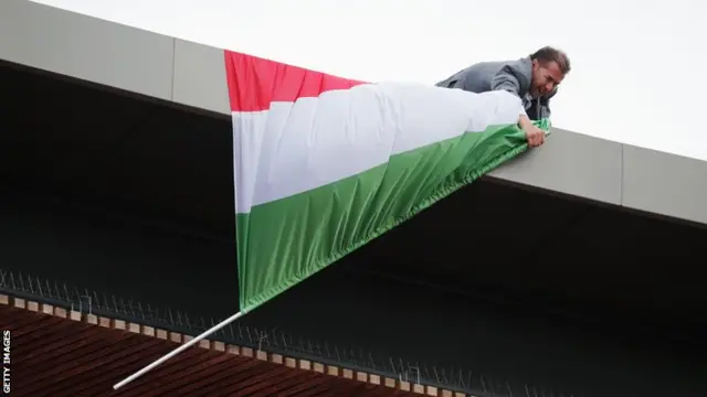 Man bringing in a flag at the European Championships