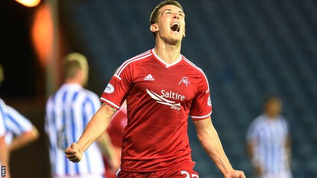 Aberdeen midfielder Ryan Jack wheels away in delight after heading in the second goal