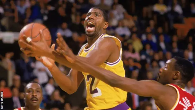 Magic Johnson of the Los Angeles Lakers shoots a lay up during an NBA game against the Houston Rockets in 1987