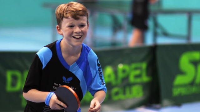 Boy plays table tennis