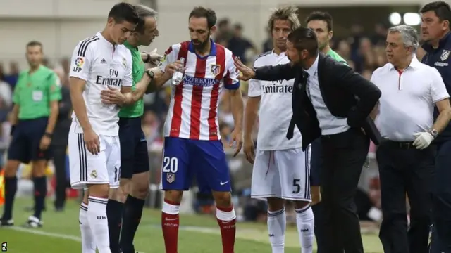 Atletico Madrid's Argentinian coach Diego Simeone argues with the 4th referee