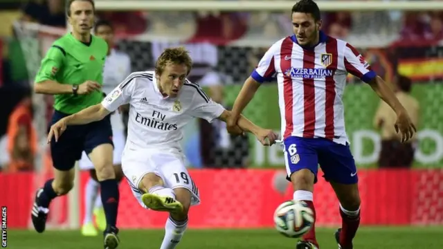 Croatian midfielder Luka Modric vies with Atletico Madrid's midfielder Koke