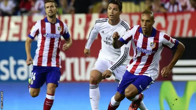 Real Madrid's Portuguese forward Cristiano Ronaldo vies with Atletico Madrid"s Brazilian defender Joa Miranda de Souza