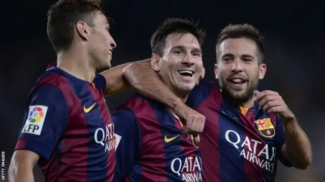 Barcelona's Argentinian forward Lionel Messi is congratulated by teammate