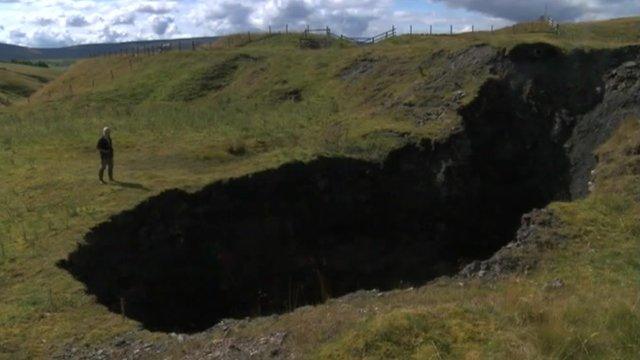 Landowner standing next to sink-hole