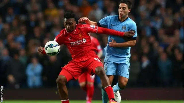 Daniel Sturridge of Liverpool holds off Samir Nasri