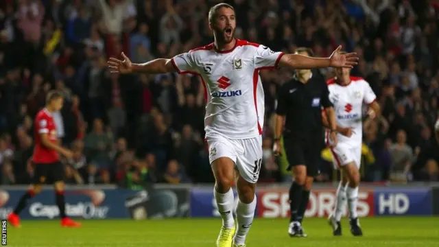 Will Grigg celebrates his goal against Manchester United