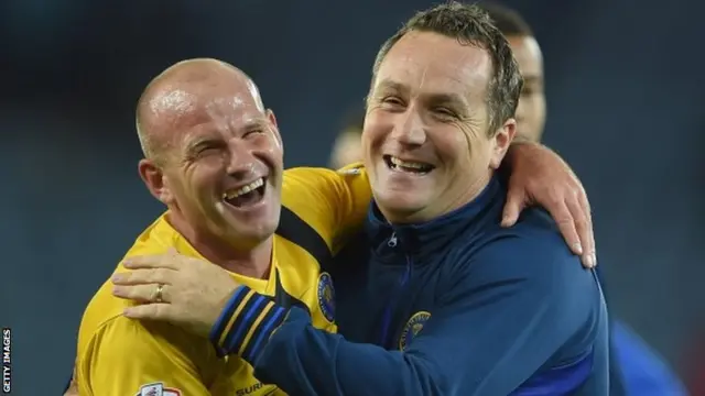 Shrewsbury manager Micky Mellon celebrates with Andy Robinson