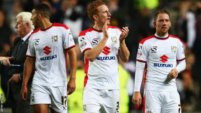 Dean Lewington of Milton Keynes Dons applauds the fans