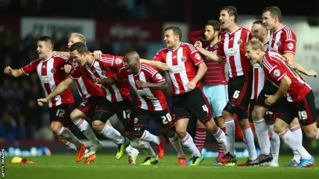 Sheffield United players celebrate after Michael Doyle of Sheffield United scored the winning penalty