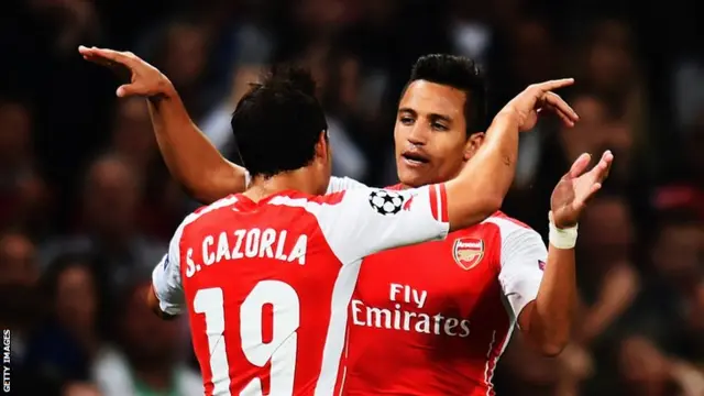 Alexis Sanchez celebrates his goal with Arsenal team mate Santi Cazorla