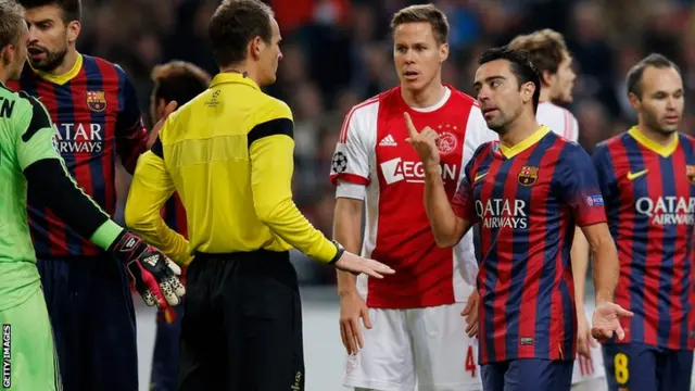 Xavi Hernandez argues with a referee as Barcelona take on Ajax