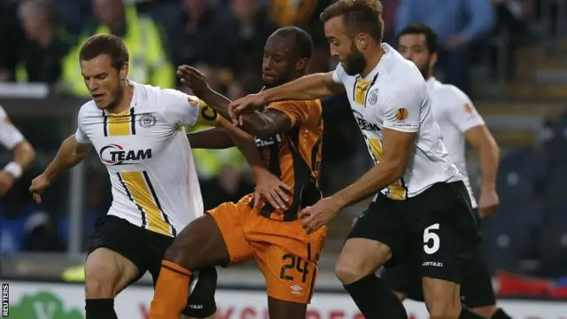 Hull City's Sone Aluko (centre) is challenged by Lokeren's Killian Overmeire (left) and Mijat Maric