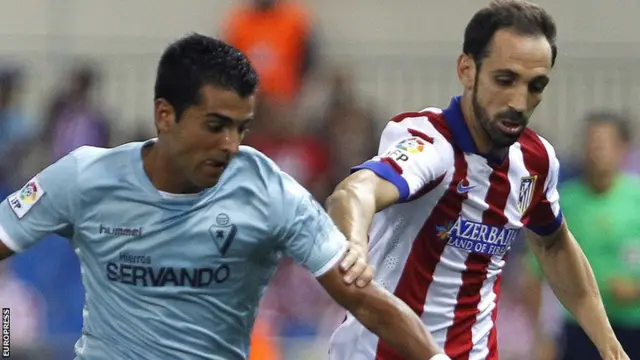 Juanfran chases the ball for Atletico Madrid