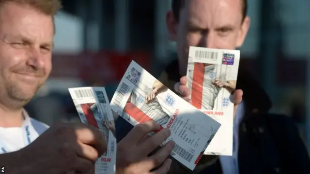 England fans proudly display their match tickets