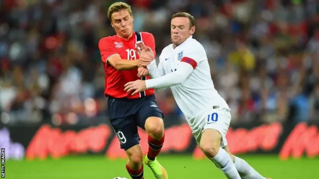 England captain Wayne Rooney (right) in action against Norway