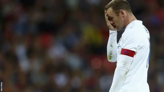 England captain Wayne Rooney wipes his face