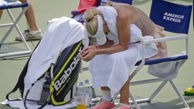 Caroline Wozniacki, of Denmark, takes a break between games