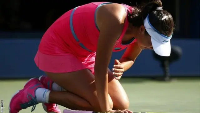 Peng Shuai of China drops to the court in pain