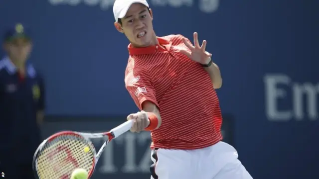 Kei Nishikori, of Japan, returns a shot against Novak Djokovic