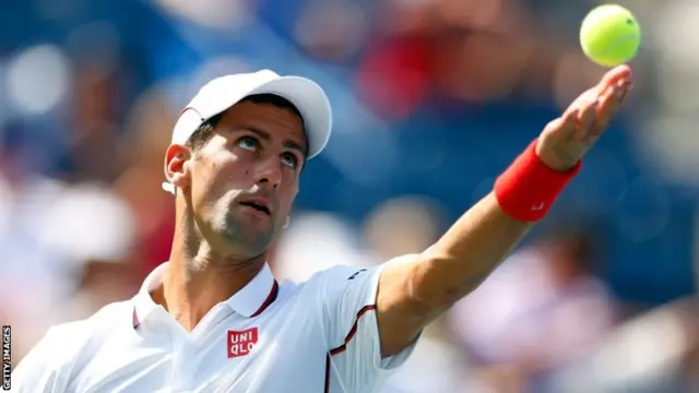 Novak Djokovic of Serbia serves against Kei Nishikori