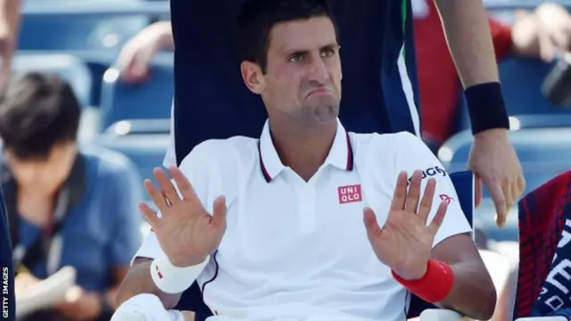 Novak Djokovic of Serbia reacts after losing the first set against Kei Nishikori