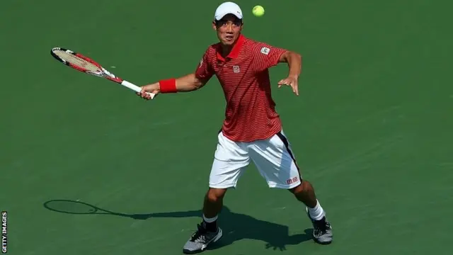 Kei Nishikori of Japan returns a shot against Novak Djokovic