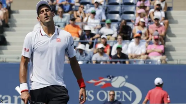 Novak Djokovic, of Serbia, reacts after a shot against Kei Nishikori