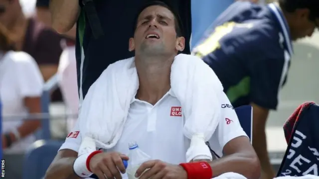 Novak Djokovic of Serbia cools off with an ice towel