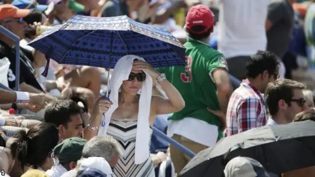 Tennis fans watch play between Kei Nishikori, of Japan, and Novak Djokovic, of Serbia,