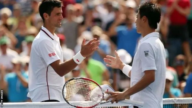 Kei Nishikori of Japan greats Novak Djokovic