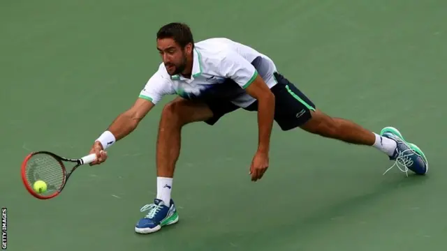 Marin Cilic of Croatia returns a shot against Roger Federer