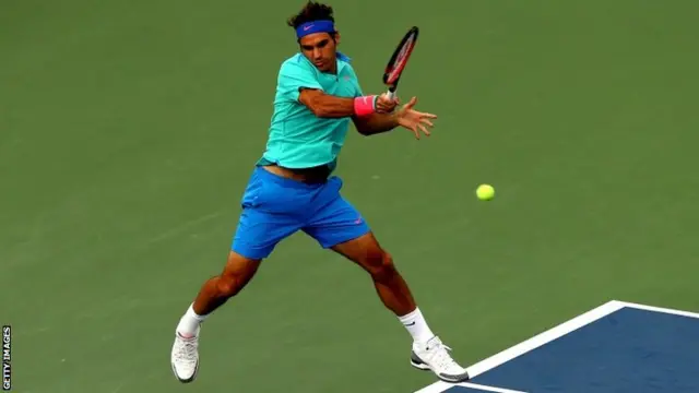 Roger Federer of Switzerland returns a shot against Marin Cilic