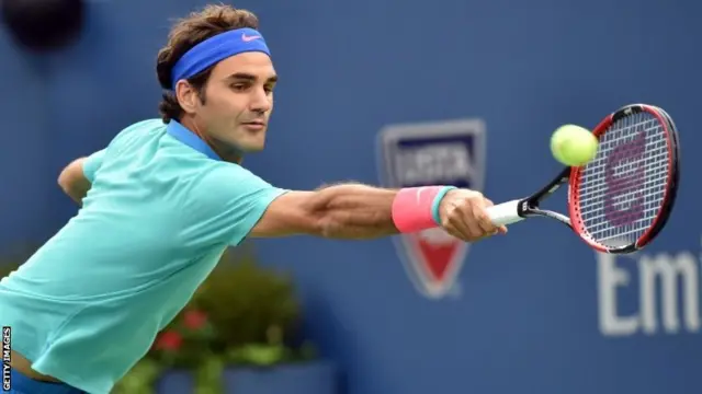 Roger Federer of Switzerland returns a shot to Marin Cilic