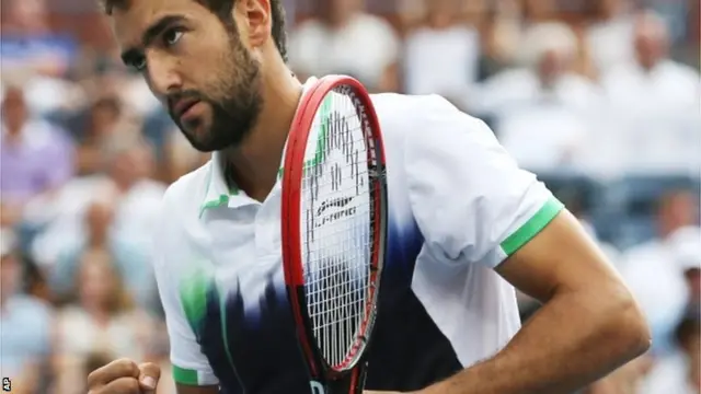 Marin Cilic, of Croatia, reacts after a shot against Roger Federer