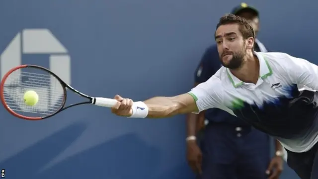 Marin Cilic of Croatia hits a return to Roger Federer