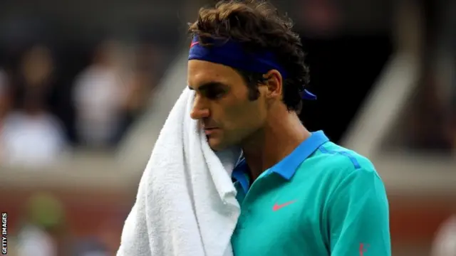 Roger Federer of Switzerland wipes his face with a towel