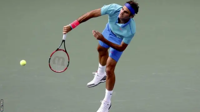 Roger Federer of Switzerland serves to Marin Cilic