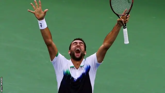 Marin Cilic of Croatia celebrates with his arms aloft