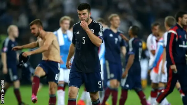 Scotland"s Grant Hanley (centre) reflects on the defeat by Germany