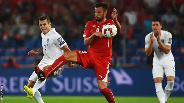 Haris Seferovic of Switzerland (centre) challenges England's Jack Wilshere