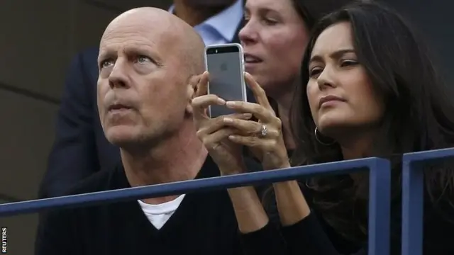 Actor Bruce Willis watches intently