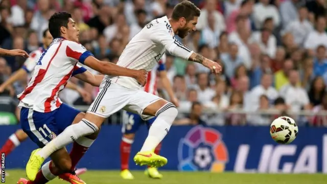 Cristian Rodriguez vies with Real Madrid's defender Sergio Ramos