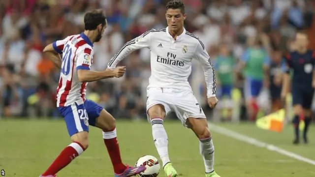 Cristiano Ronaldo duels for the ball with Atletico de Madrid"s Juan Fran